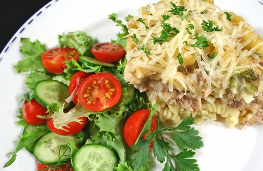 Delicious tuna and pasta bake with a tossed salad ready to serve.