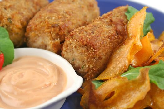 Crumbed tuna croquettes with sweet potatoes and a rocket salad.