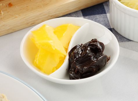 The iconic Australian spread vegemite with butter in a dish.