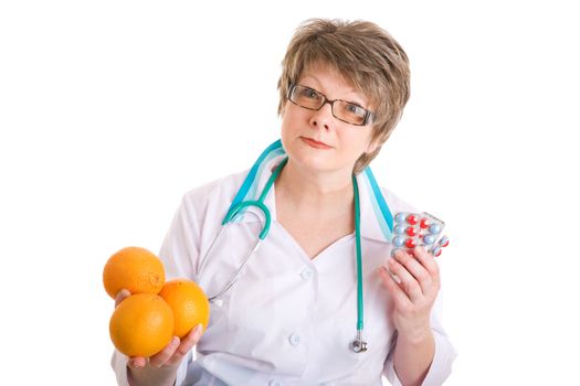 smiling doctor with medcines in one hand and oranges in another