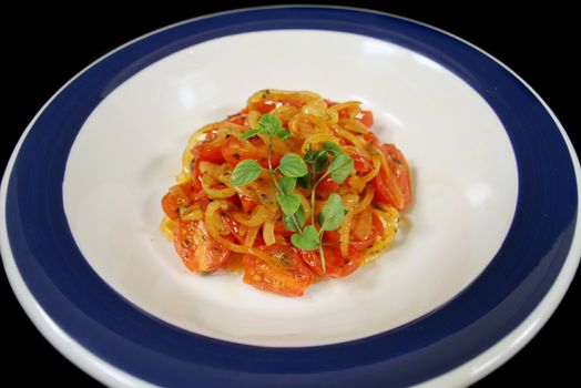 Warm salad consisting of cherry tomatoes and caramelized onion with oregano. 