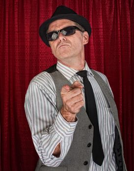 Cool retro style man in pinstripe shirt pointing