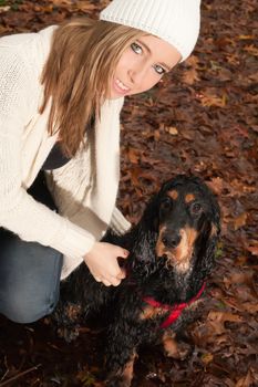 Girl and her dog are having a wet time in the rain