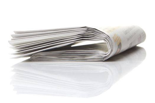 several newspapers, journals stacked on white background