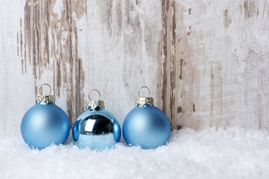 Christmas decoration with wood background, snow and christmas balls turquoise
