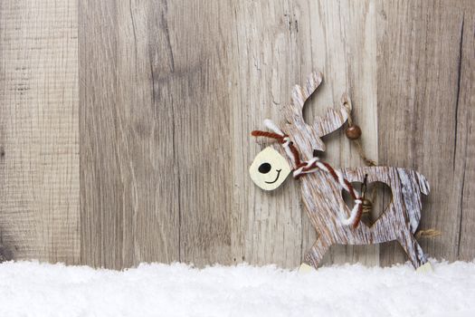 christmas decoration with wood background, snow, elk