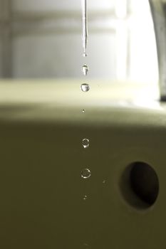 The fluid motion of water splashing as it is poured.