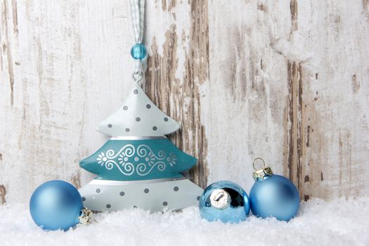 Christmas decoration with wood background, snow, christmas balls and christmas tree turquoise