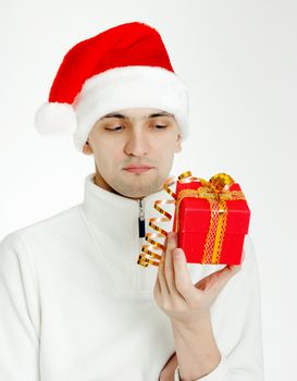 Attractive man in a Santa hat with Christmas gift