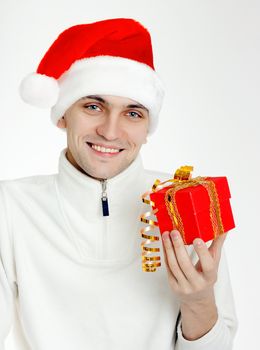 Attractive man in a Santa hat with Christmas gift