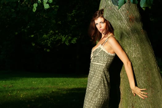 Beautiful young woman in summer forest