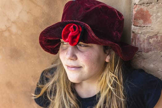 Teen girl wearing red flower material hat