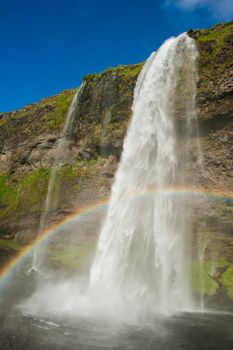 Seljalandsfoss is one of the most beautiful waterfalls on the Iceland. It is located on the South of the island. With a rainbow.