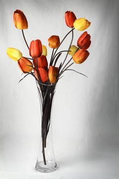 Artificial flowers in a glass vase