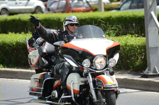 WROCLAW, POLAND - MAY 18: Unidentified motorcyclist rides Harley-Davidson and greets spectators. Around 8 thousands riders joined Super Rally  from 16 to 20 May 2013 in Wroclaw.