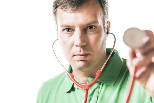 portrait of a doctor in green shirt holding a red stethoscope