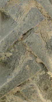 Close-up of tractor tire tread as background.