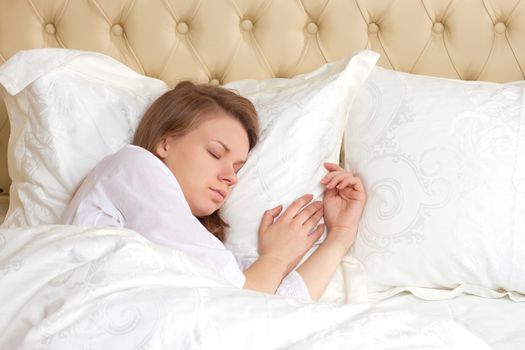 Young girl sleeping in bed