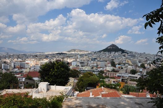 View of the city of Athens Greece and Lycabettus hill as seen from Plaka.