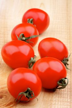 Heap of Fresh Ripe Cherry Tomatoes on Rustic Wooden background