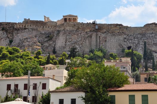 Houses at Plaka neighborhood and the Acropolis walls, Athens, Greece.