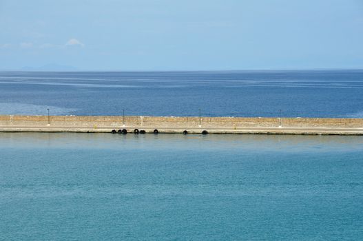 Jetty wall sea and sky horizon abstract background.