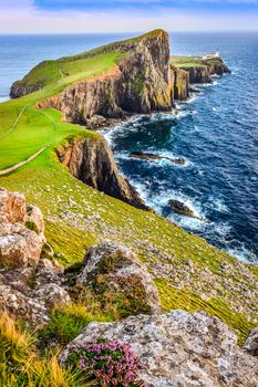 Vertical view of Neist Point lighthouse and rocky ocean coastline, Scotland, United Kingdom