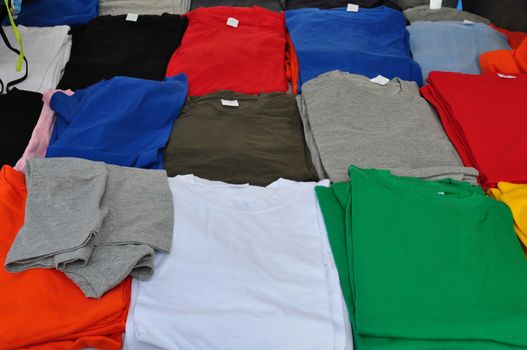 Colorful short sleeve t-shirts background. Casual summer clothes.