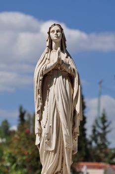 Virgin Mary hands joined in prayer marble funerary statue.