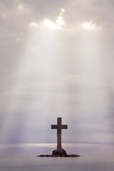 A Cross made of stone erect on an island off shore