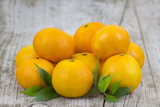 fresh tangerines on old wooden background