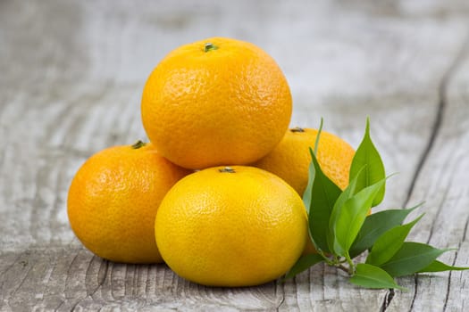 fresh tangerines on old wooden background