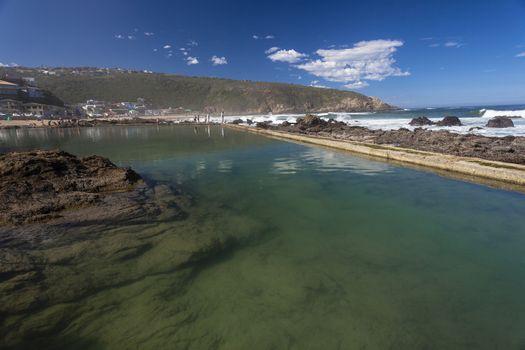 Rock concrete tidal pool landscape by the ocean sea waters at Herolds Bay South-Africa