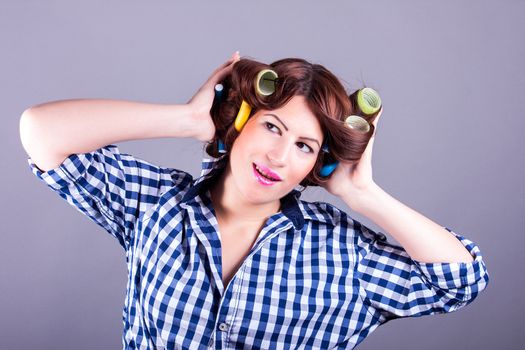 portrait of sexy housewife with curlers