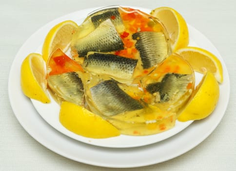 Herring in jely, on a plate