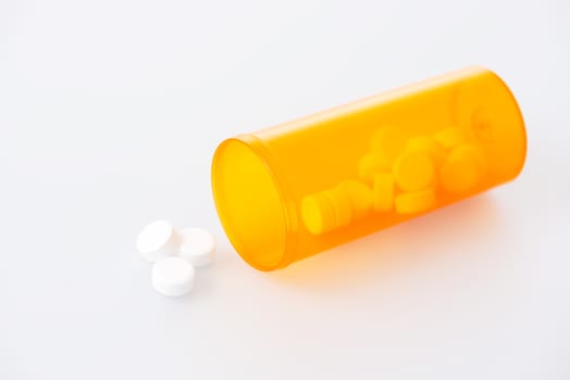 Prescription pills spilling out of bottle