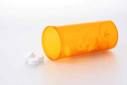 Prescription pills spilling out of bottle