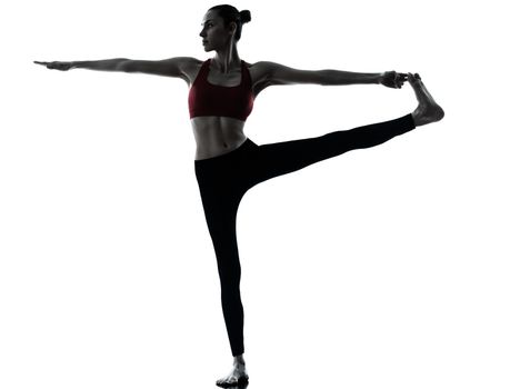 one caucasian woman exercising yoga Revolved Hand to Big Toe Pose in silhouette studio isolated on white background