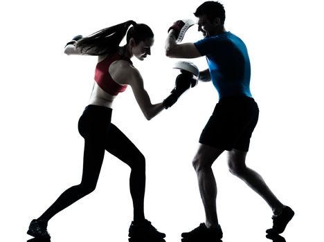 personal trainer man coach and woman exercising boxing silhouette studio isolated on white background