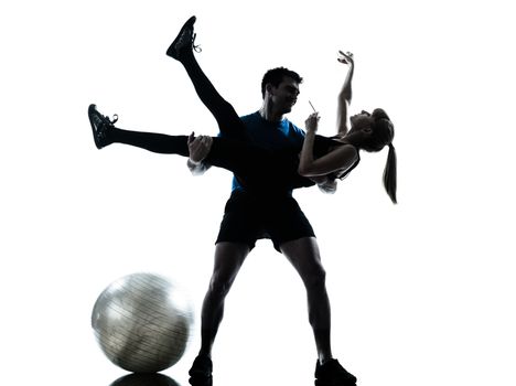 caucasian aerobics instructor with mature woman exercising fitness workout in silhouette studio isolated on white background