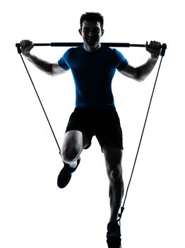 one caucasian man exercising gymstick workout fitness in silhouette studio isolated on white background