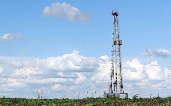 land oil drilling rig on field landscape