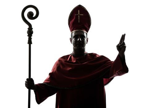 one man cardinal bishop silhouette saluting blessing in studio isolated on white background