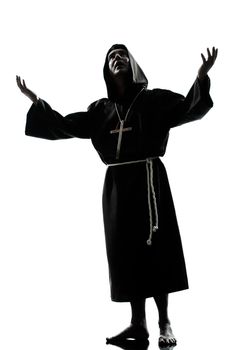 one caucasian man priest praying silhouette in studio isolated on white background