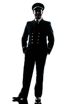 one caucasian man in airline pilot uniform in studio isolated on white background silhouette