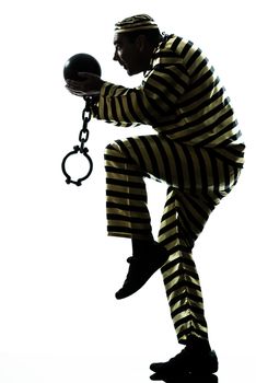one caucasian man prisoner criminal escaping with chain ball silhouette in studio isolated on white background