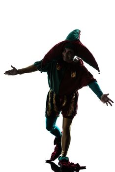 one caucasian man in jester costume saluting silhouette in studio isolated on white background