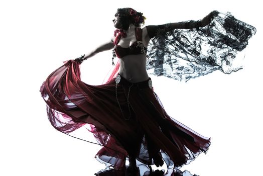 one arabic woman belly dancer dancing silhouette studio isolated on white background