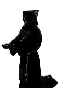 one caucasian man priest praying silhouette in studio isolated on white background