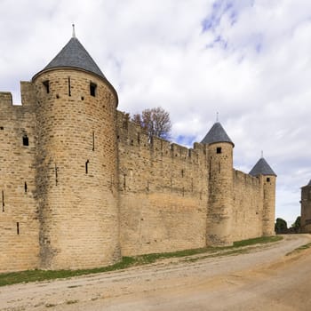 Carcassonne, France - November 2, 2013: View of the medieval walled city of Carcassonne and its castle on a sunny day.